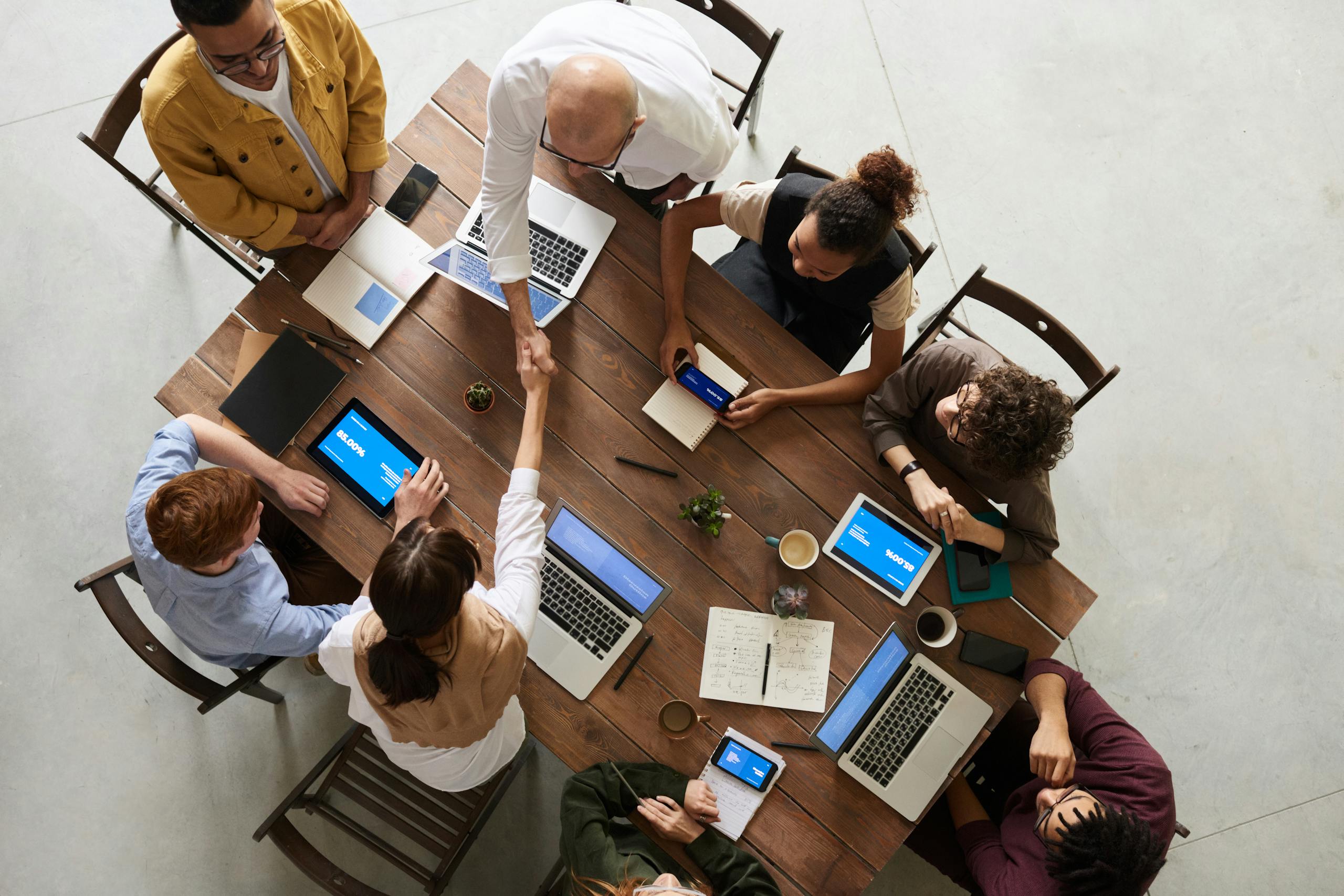 Overhead view of a business desk with charts and a laptop, ideal for data analysis concepts.